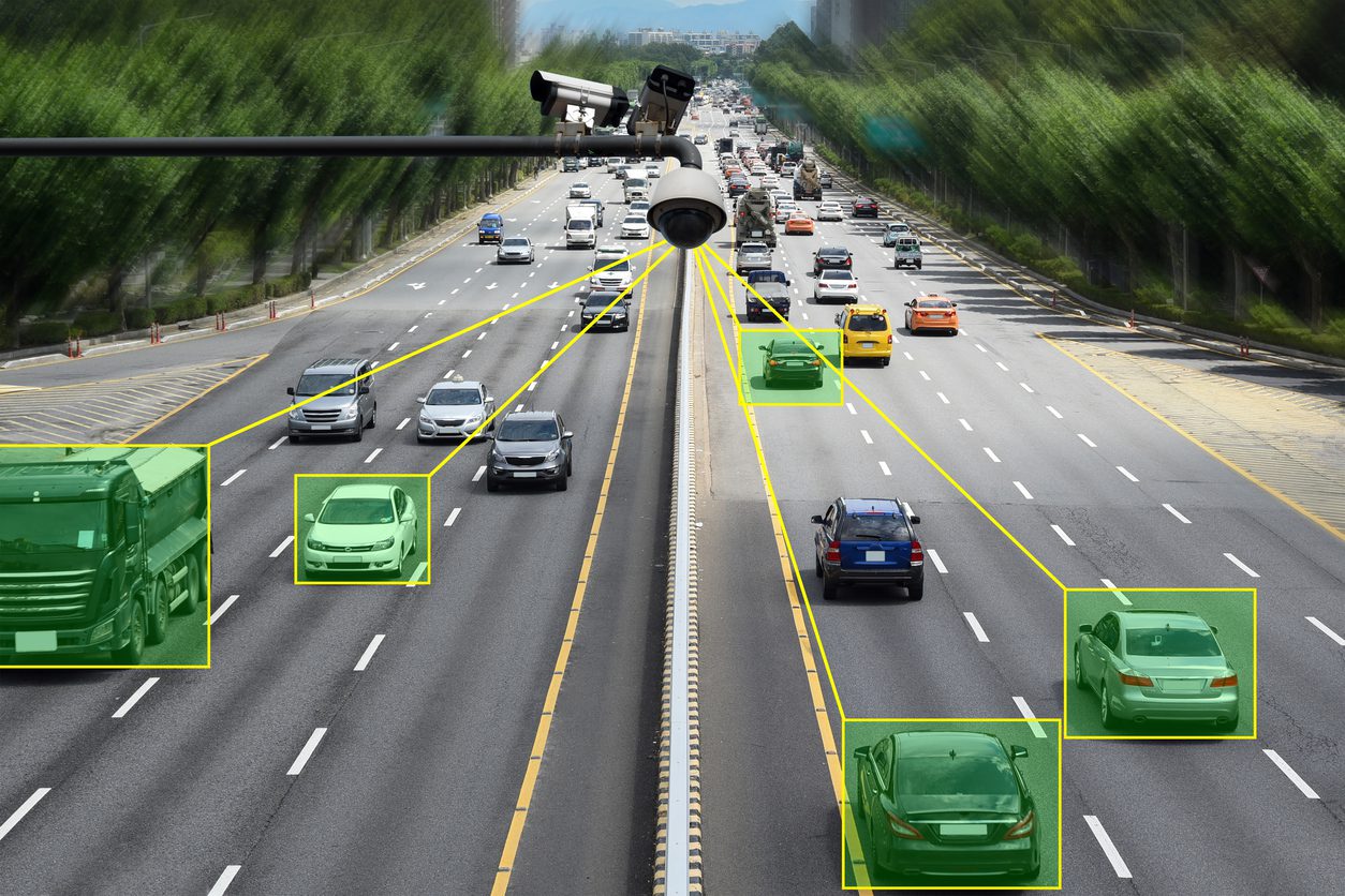 A picture of cars on the road with green eyes.