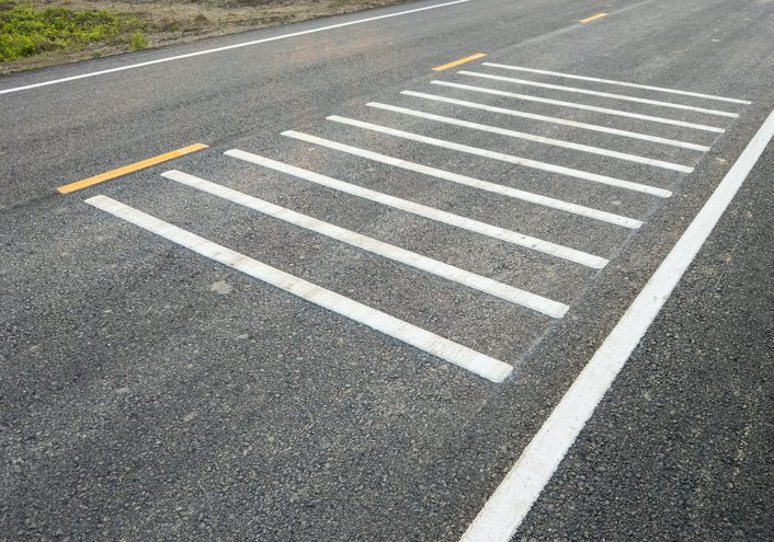 A road with white lines on the side of it.