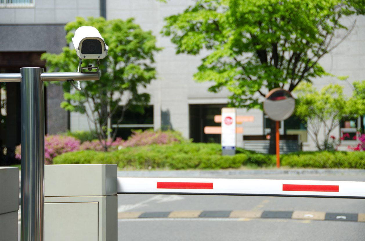 A red and white camera on the side of a road.